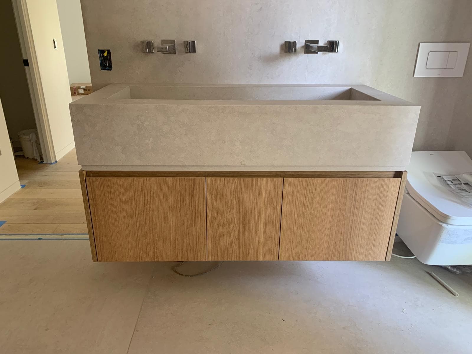 Modern floating bathroom vanity with wood finish and stone countertop