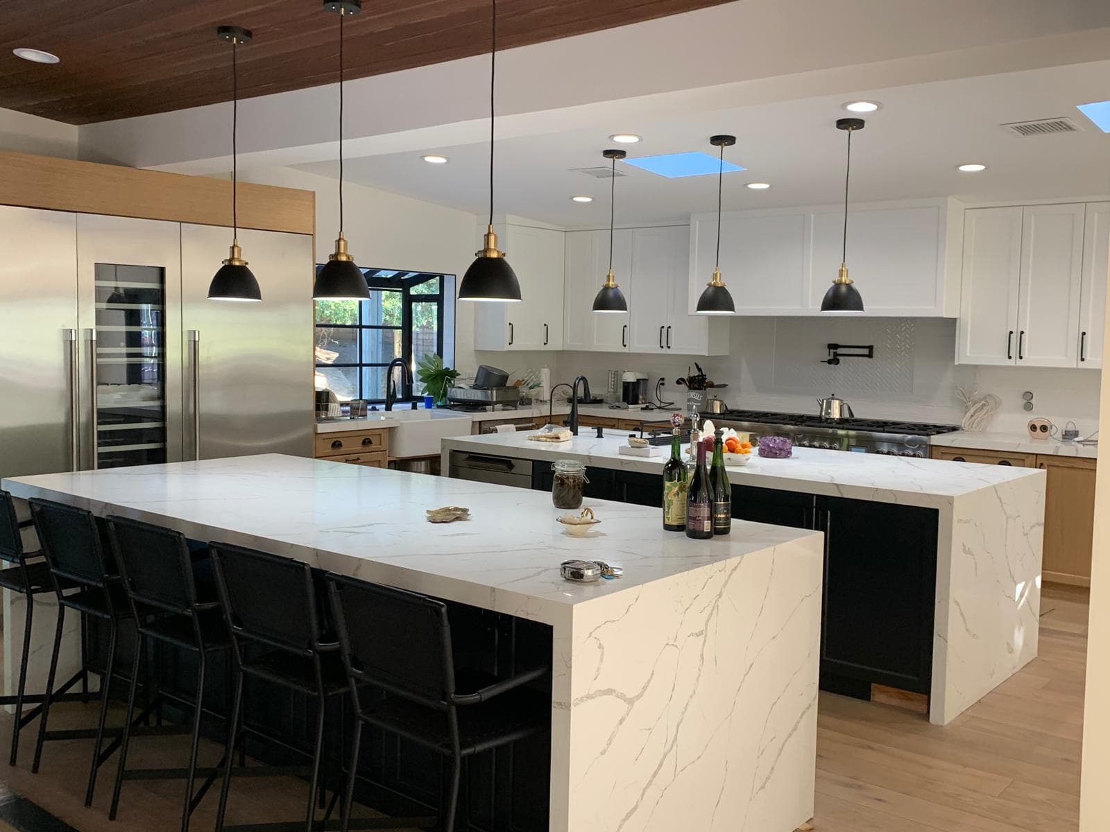 Detail of transitional kitchen cabinets aligned over marble countertops